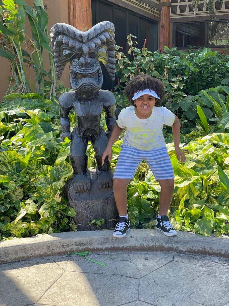 Caleb with a tiki at the Polynesian Cultural Center