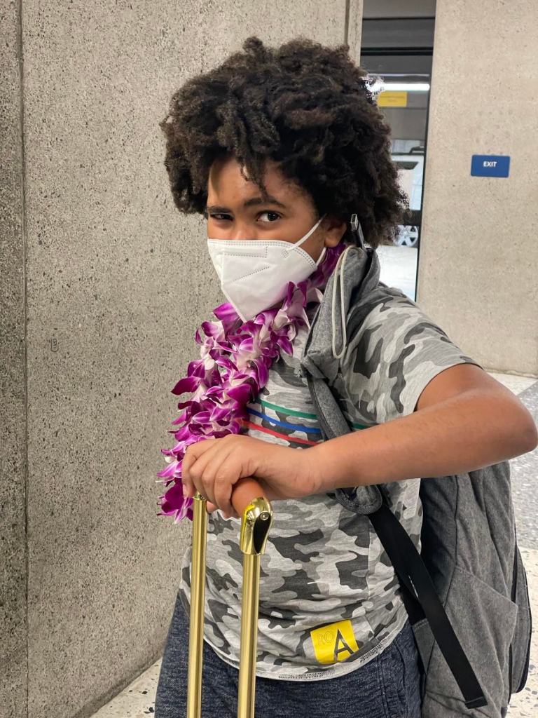 Caleb Dade traveling to the airport with mask on